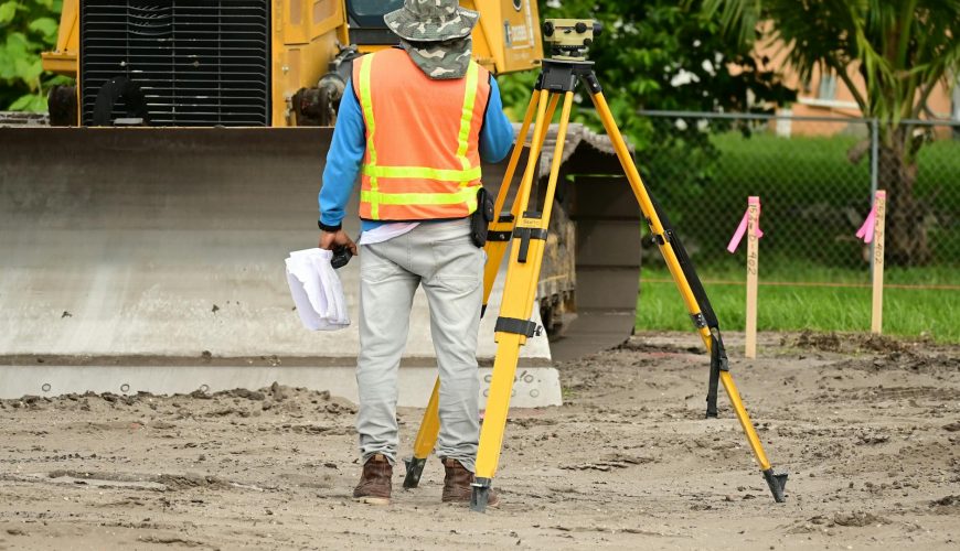 land surveyor measuring — photo Nelson Axigoth / Pexels