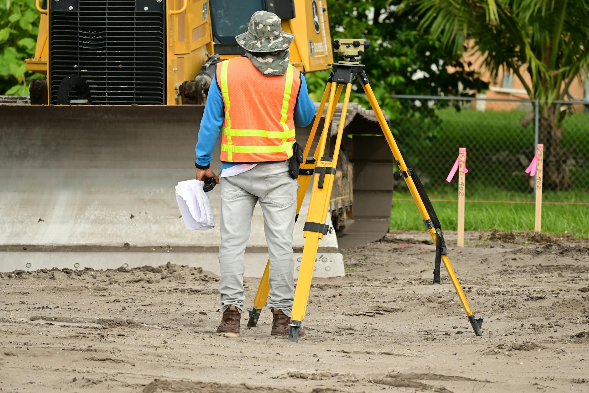 land surveyor measuring — photo Nelson Axigoth / Pexels